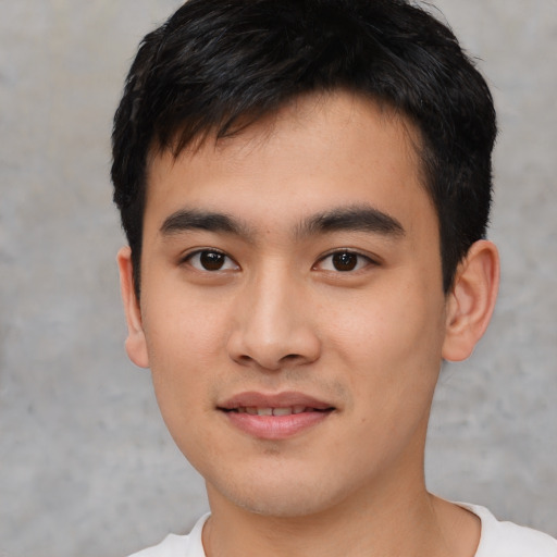 Joyful asian young-adult male with short  black hair and brown eyes
