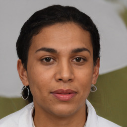 Joyful latino young-adult female with short  brown hair and brown eyes