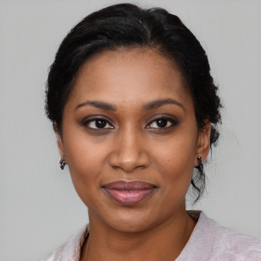 Joyful black young-adult female with medium  black hair and brown eyes
