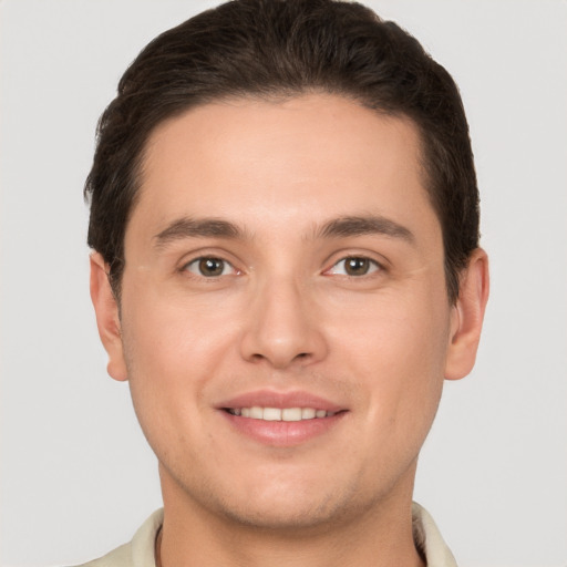 Joyful white young-adult male with short  brown hair and brown eyes