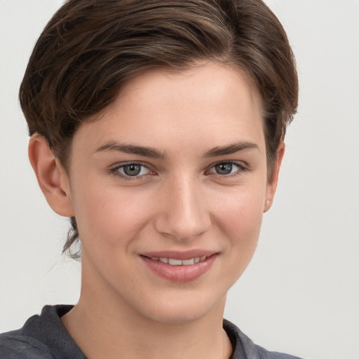 Joyful white young-adult female with medium  brown hair and grey eyes