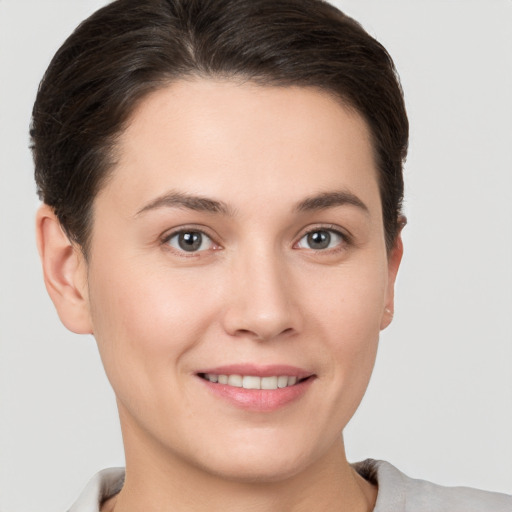 Joyful white young-adult female with short  brown hair and brown eyes