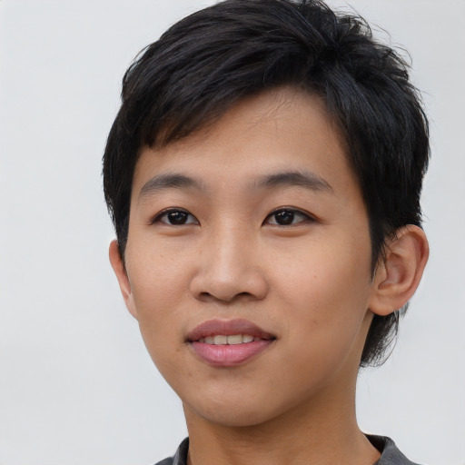 Joyful asian young-adult male with short  black hair and brown eyes