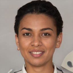 Joyful latino young-adult female with short  brown hair and brown eyes