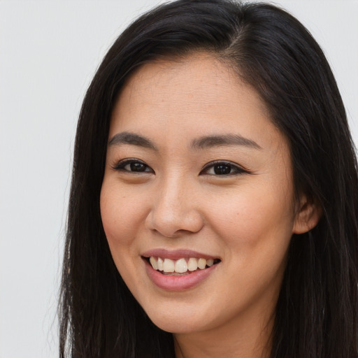 Joyful asian young-adult female with long  brown hair and brown eyes