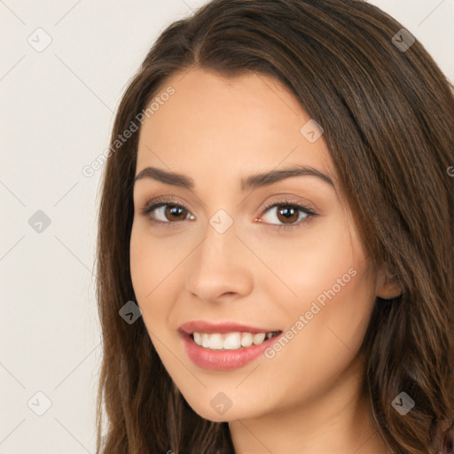 Joyful white young-adult female with long  brown hair and brown eyes