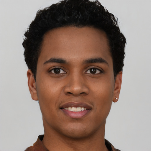 Joyful black young-adult male with short  black hair and brown eyes