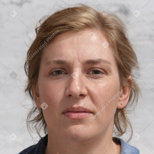 Joyful white adult female with medium  brown hair and blue eyes