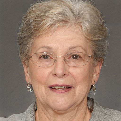 Joyful white middle-aged female with short  brown hair and blue eyes