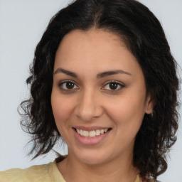 Joyful latino young-adult female with medium  brown hair and brown eyes