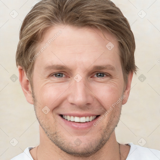 Joyful white young-adult male with short  brown hair and grey eyes