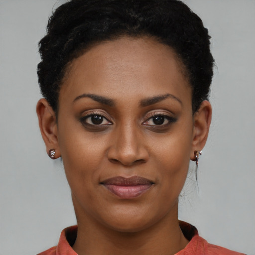 Joyful black young-adult female with short  brown hair and brown eyes