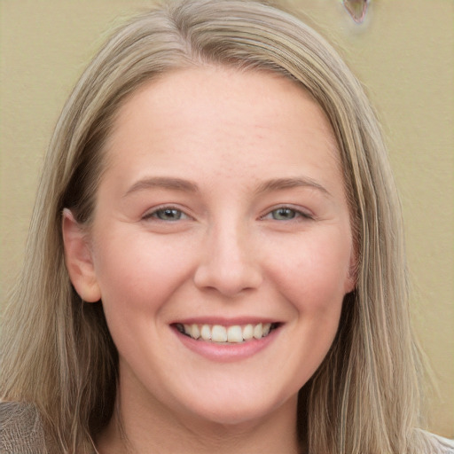 Joyful white young-adult female with long  brown hair and blue eyes