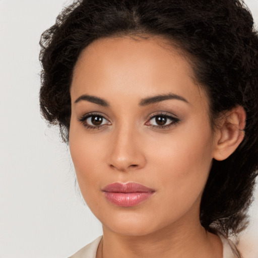 Joyful latino young-adult female with medium  brown hair and brown eyes