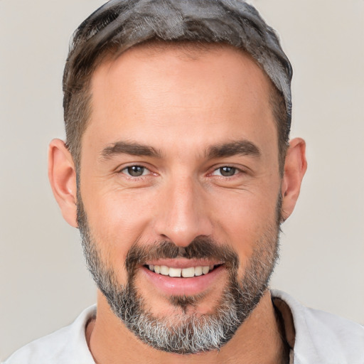 Joyful white adult male with short  brown hair and brown eyes