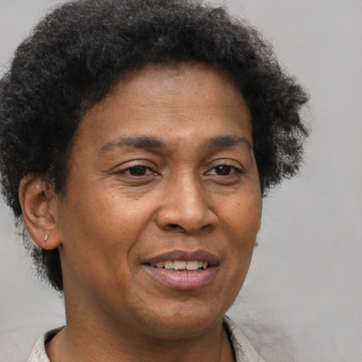 Joyful black adult male with short  brown hair and brown eyes