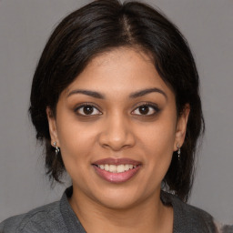 Joyful white young-adult female with medium  brown hair and brown eyes