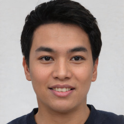 Joyful asian young-adult male with short  black hair and brown eyes