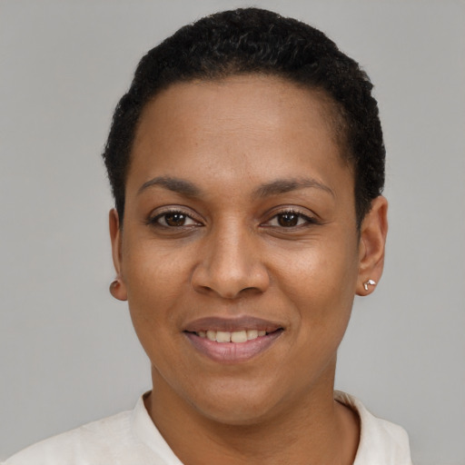 Joyful black young-adult female with short  black hair and brown eyes
