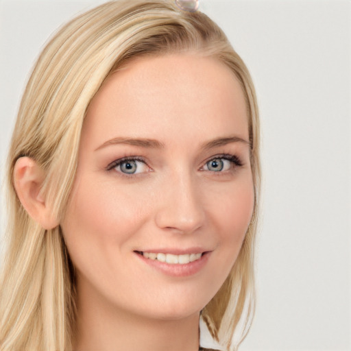 Joyful white young-adult female with long  blond hair and blue eyes