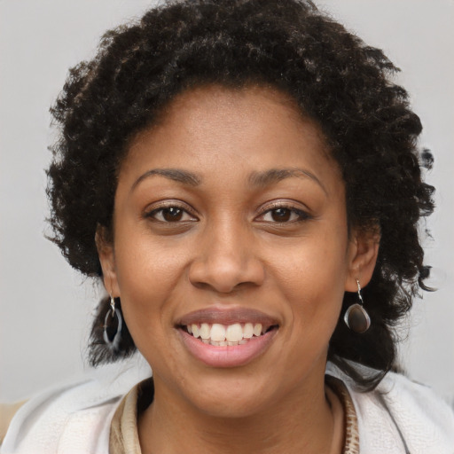 Joyful black young-adult female with medium  brown hair and brown eyes