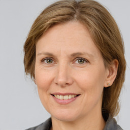 Joyful white adult female with medium  brown hair and grey eyes