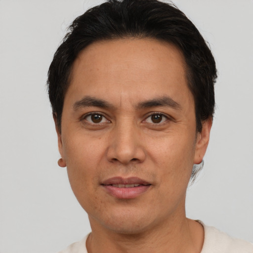 Joyful asian adult male with short  brown hair and brown eyes