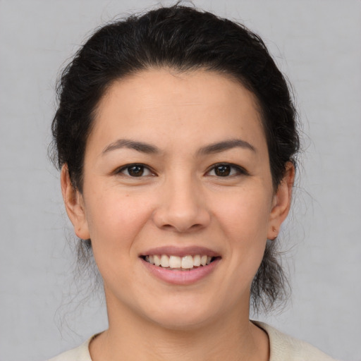 Joyful asian young-adult female with medium  brown hair and brown eyes