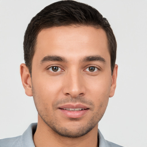 Joyful white young-adult male with short  brown hair and brown eyes