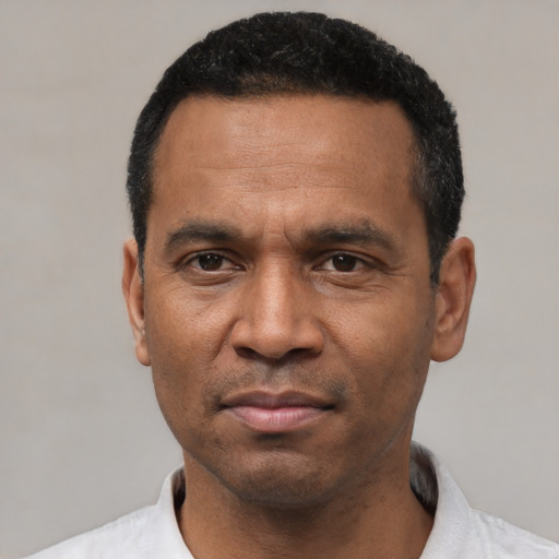 Neutral latino adult male with short  black hair and brown eyes