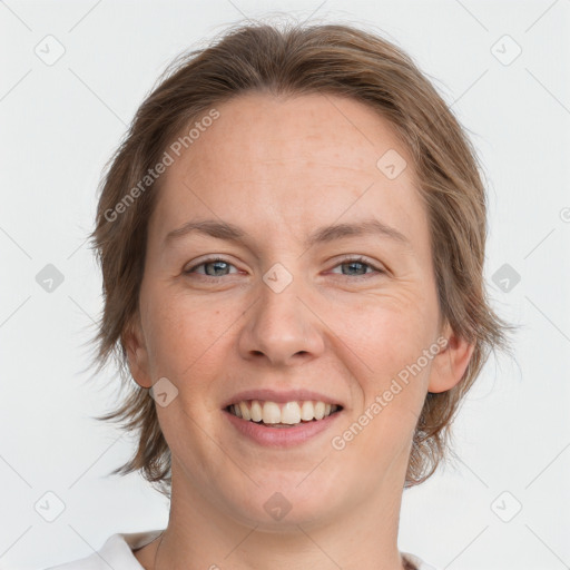 Joyful white adult female with medium  brown hair and grey eyes