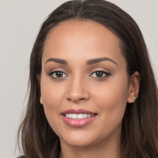 Joyful white young-adult female with long  brown hair and brown eyes