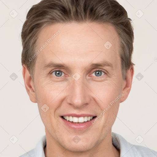 Joyful white adult male with short  brown hair and grey eyes