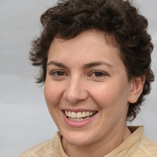 Joyful white adult female with medium  brown hair and brown eyes