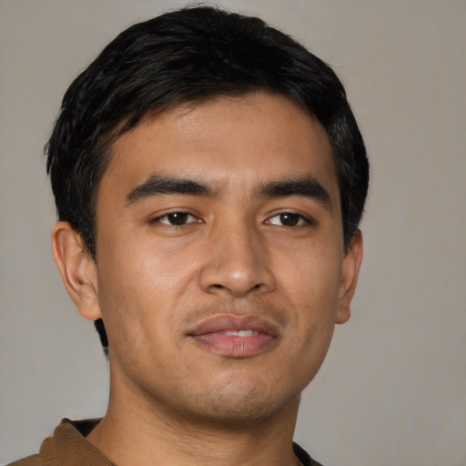 Joyful asian young-adult male with short  black hair and brown eyes