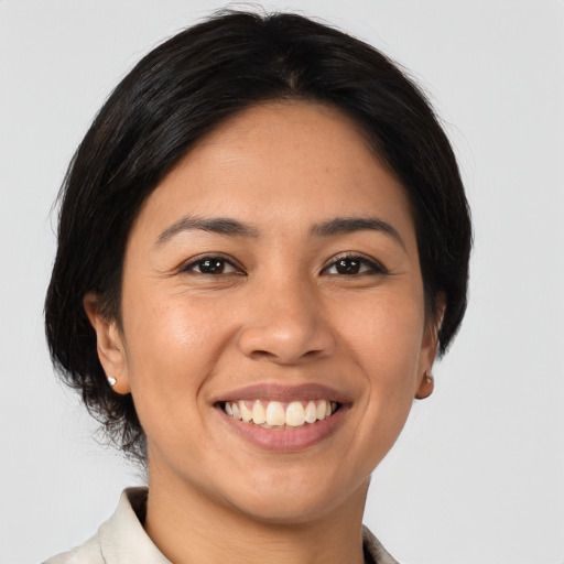 Joyful latino young-adult female with medium  brown hair and brown eyes