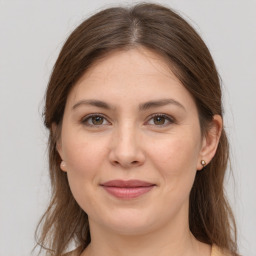 Joyful white young-adult female with long  brown hair and grey eyes