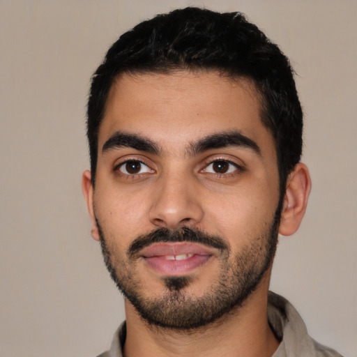 Joyful latino young-adult male with short  black hair and brown eyes