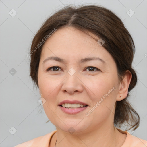 Joyful white adult female with medium  brown hair and brown eyes