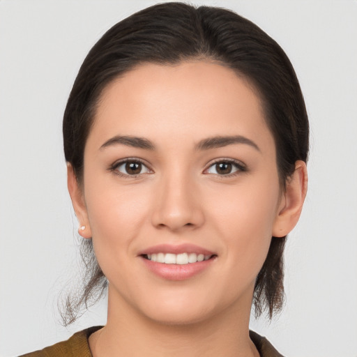 Joyful white young-adult female with medium  brown hair and brown eyes