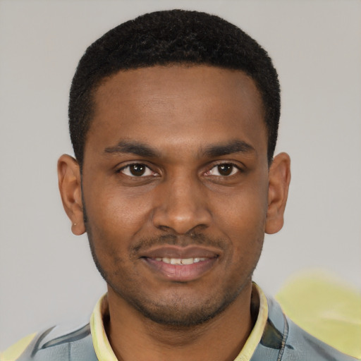 Joyful black young-adult male with short  black hair and brown eyes