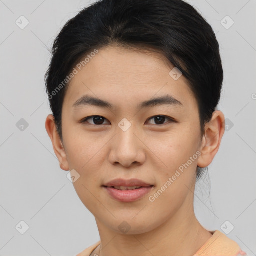 Joyful asian young-adult female with short  black hair and brown eyes