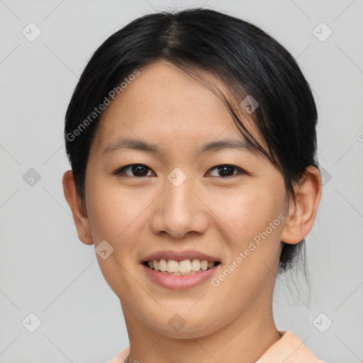 Joyful asian young-adult female with short  brown hair and brown eyes