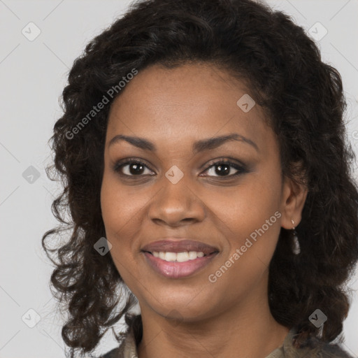 Joyful black young-adult female with long  brown hair and brown eyes