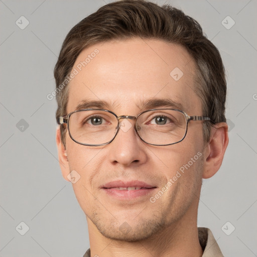 Joyful white adult male with short  brown hair and grey eyes