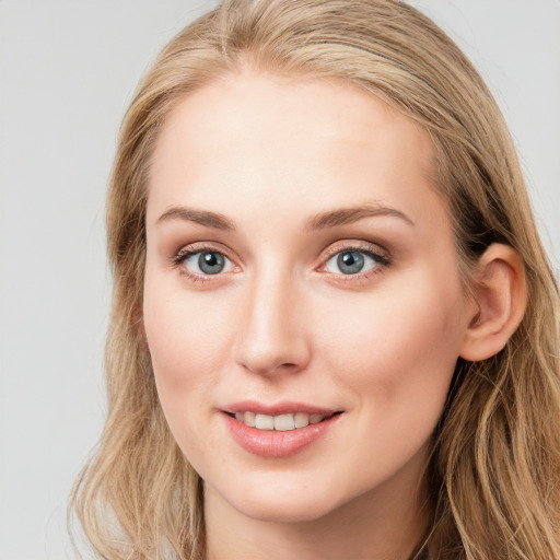 Joyful white young-adult female with long  brown hair and blue eyes