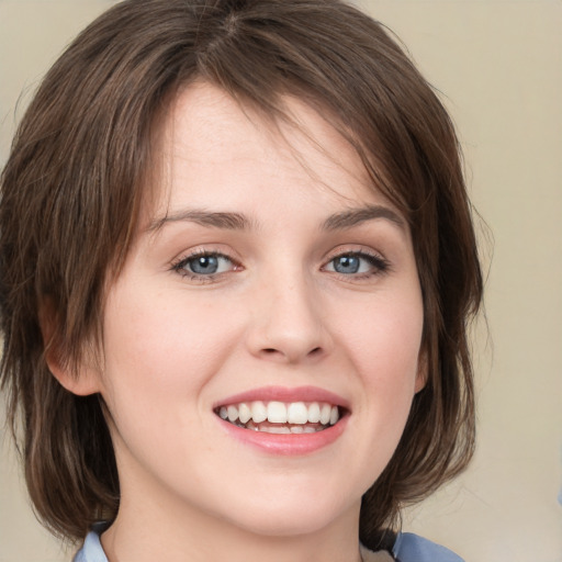 Joyful white young-adult female with medium  brown hair and blue eyes