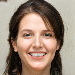 Joyful white adult female with medium  brown hair and brown eyes