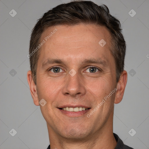 Joyful white adult male with short  brown hair and brown eyes