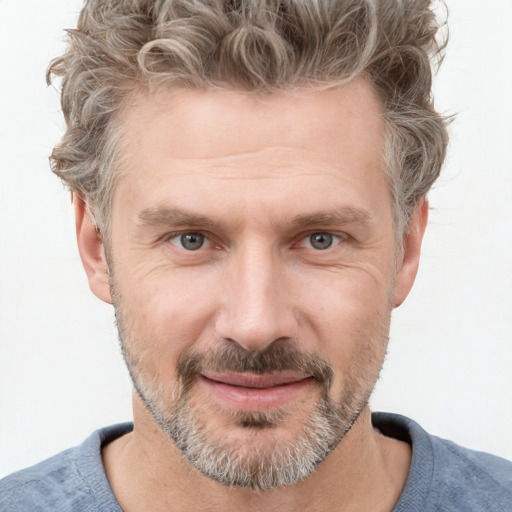 Joyful white adult male with short  brown hair and grey eyes